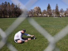 Saskatchewan Roughrider linebacker Micah Teitz stretches in a field near Griffiths Stadium after the first day of the Riders training camp was cancelled due to a player strike on Sunday May 15, 2022.