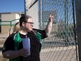 Christina Feist peers through the Griffiths Stadium fence where she was hopeful to watch the Saskatchewan Roughriders open training camp.