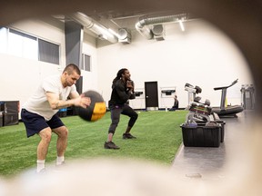 Saskatchewan Roughriders Matt Watson (left) and Stephen Denmark train at Ignite Athletics, since the official training camp is still on hold as they wait for a deal. Photo taken in Saskatoon, Sask. on Tuesday May 17, 2022.