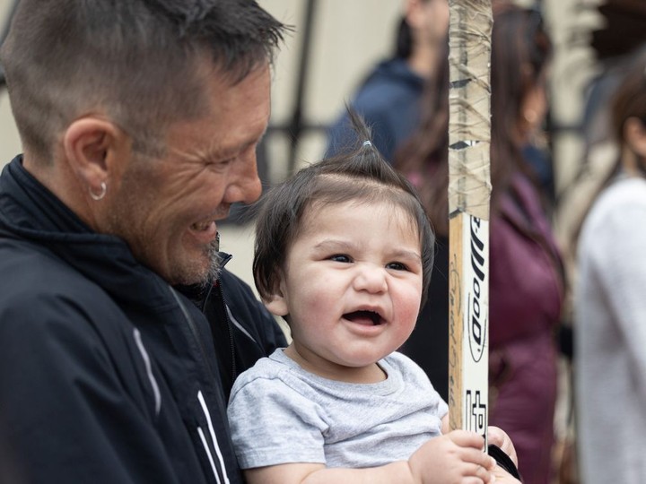  Fred Sasakamoose’s great-great-grandchild holds his hockey stick during the unveiling of the Fred Sasakamoose statue at SaskTel Centre in Saskatoon on May 18, 2022.