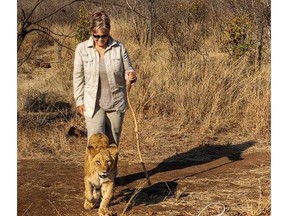 Deborah MacEwen walks with a lion cub in Botswana, Africa.