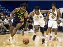 Saskatchewan Rattlers guard Scottie Lindsey (20) battles for the ball with Niagara River Lions forward Alonzo Walker (11) during first quarter CEBL action in Saskatoon on Wednesday, May 25, 2022.