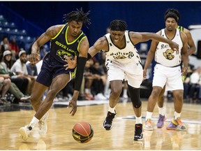Saskatchewan Rattlers guard Scottie Lindsey (20) battles for the ball with Niagara River Lions forward Alonzo Walker (11) during first quarter CEBL action in Saskatoon on Wednesday, May 25, 2022.
