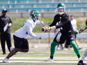 Saskatchewan Roughriders quarterback Cody Fajardo hands the ball off during Tuesday's practice.