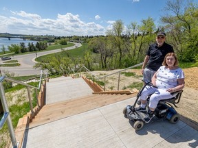 Carol and Neil Conley stand at the top of the newly renovated area of Meewasin Trail that includes a large staircase with no alternatives for accessibility. Carol, who uses a mobility scooter, cannot access this part of the trail as no ramp was built to accompany the stairs.