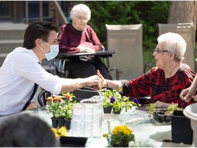 Prime Minister Justin Trudeau visits with residents, like Shirley Wenzel (right), at St. Ann's Senior Citizen's village during his visit to Saskatoon. Photo taken in Saskatoon, Sask. on Wednesday May 25, 2022.