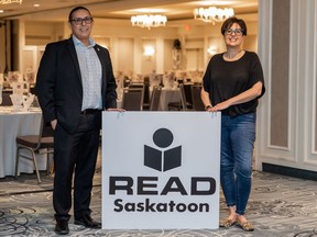 READ Saskatoon Board chair Jarvis Pelletier, left, and executive director Sheryl Harrow-Yurach stand with the original READ Saskatoon logo. READ Saskatoon is celebrating the success of its Learn Together, Grow Together campaign and announcing a new name for the organization.