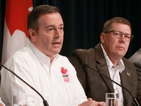 Alberta Premier Jason Kenney, left, appears with Saskatchewan Premier Scott Moe in July of 2019 in Saskatoon, Sask.