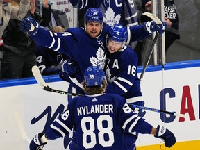 Maple Leafs' Mitchell Marner and William Nylander congratulate Auston Matthews on his goal against the Tampa Bay Lightning during the second period in Game 1 of their first-round Stanley Cup playoff series at Scotiabank Arena on Monday, May 2, 2022.