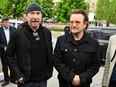 Bono, right, activist and front man of the Irish rock band U2 and guitarist David Howell Evans aka 'The Edge,' left visits the site of a mass grave by the Church of St. Andrew Pervozvannoho All Saints in the Ukrainian town of Bucha, near Kyiv on May 8, 2022.