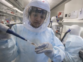 Research scientists work in one of VIDO’s Containment Level 3 laboratories. PHOTO: VIDO/DAVID STOBBE