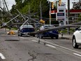 The scene from Merivale Road at Viewmount Drive on Sunday, May 22, 2022. Cars were trapped under wires with many downed hydro poles. Merivale Road is closed in this area.