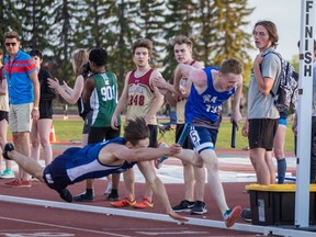 Bethlehem's Judah Arthurs dives across the finish line and helps his team win the 4X400-m relay at the city track and field championships. He edged out Walter Murray's Logan Johnston in a race that was won by 1/100th of a second. (Photo by Victor Pankratz)