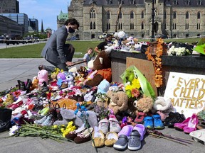 Prime Minister Justin Trudeau visits a memorial at the Cantennial Flame on Parliament Hill in Ottawa on Tuesday, June 1, 2021, in recognition of discovery of unmarked graves at the site of a former residential school in Kamloops, B.C.