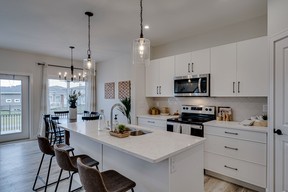 Scandinavian style elements, including a crisp white colour palette and natural wood accents, distinguish the Denali show home at North Ridge Towns Brighton. SUPPLIED