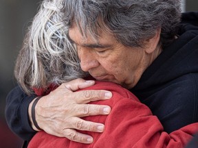 Brian Gallagher hugs friends and family members outside the Saskatoon provincial courthouse on June 2, 2022.