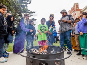 BEST PHOTO SASKATOON, SK--JUNE 14/2022 - 0615 News School Closing - School children from Princess Alexandra toss small packets of tobacco into the ceremonial fire at King George after a closing ceremony for Princess Alexandra school. Students will be integrating into King George school while a new community school is built on the site of Princess Alexandra school. Photo taken in Saskatoon, SK on Tuesday, June 14, 2022.