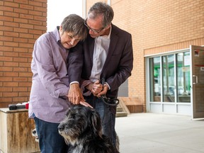 Darryl (left) and Rick Boguski made the trip from Alberta to Saskatoon provincial court with their dogs Gracie and June in hopes of facing Brent James Gabona for the first time, and to request that the publication ban on Darryl's identity be lifted.