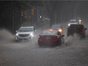 Cars splash through large puddles along Clarence Avenue as heavy rains caused flooding around Saskatoon, SK on Monday, June 20, 2022.