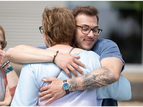 Humboldt Broncos bus crash survivor Kaleb Dahlgren hugs Carol Brons at the unveiling of the new Broncos Memorial Garden outside the Humboldt District Health Complex. Photo taken in Saskatoon, Sask. Wednesday, June 22, 2022.