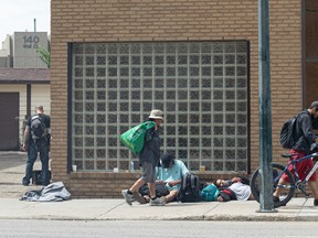 People hang out outside the Saskatoon Tribal Council Wellness Centre at 145 First Avenue North on June 23, 2022.