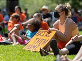 Guests listen to speakers at the Bring Them Home event organized by youth advocate Allison Forsberg at Kiwanis Park in Saskatoon on July 1, 2021.
