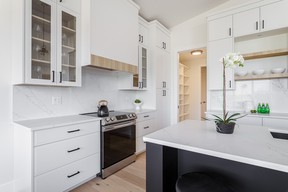 The 2022 STARS Lottery home’s kitchen features custom cabinetry by Hinge Designs. The floor-to-ceiling cabinets are complemented by white quartz countertops, a marble-style tile backsplash, and white oak accents. SUPPLIED