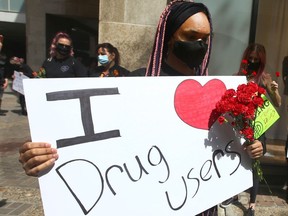 Supporters gather in downtown Calgary on Friday, June 11, 2021, in a show of solidarity with drug users. The "war on drugs" rhetoric from Premier Jason Kenney and Conservative leader candidate Pierre Poilievre is not a compassionate and productive approach to the issue of drug addiction, writes Benjamin Perrin.