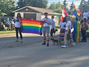 Members of Meadow Lake Pride hold a rainbow flag during this year's expanded Pride Month celebrations in the city.