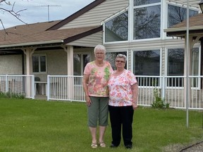 Former Cari-Villa tenant Cathy Finkle, right, stands with fellow tenant Pat Henderson, left, in front of the Carievale, Sask. housing complex several months after a fire on January 11, 2022 closed the majority of suites. Supplied by Rhonda Halliday
