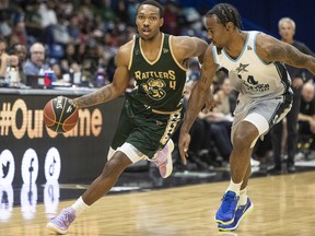 Saskatchewan Rattlers guard Tony Carr (4) drives the ball under pressure from Scarborough Shooting Stars forward Isiaha Mike (24) during CEBL action in Saskatoon on Wednesday, June 15, 2022.