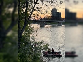 A Saskatoon Fire Department crew searches the South Saskatchewan River on July 2, 2022. Police later confirmed a seven-year-old boy found in the water was pronounced dead in hospital.