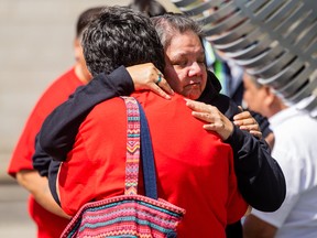 Diane Morin, in black, receives a hug outside the Saskatoon Police Headquarters. Diane is the mother of Ashley Morin, whose July 2018 disappearance remains unsolved. Morin's loved ones have held a walk from Saskatoon to North Battleford in her honour every year since she went missing.
