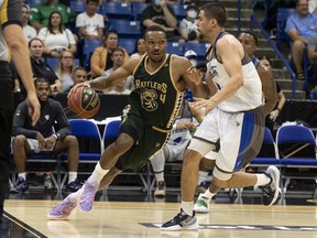 Saskatchewan Rattlers guard Tony Carr drives the ball under pressure from Guelph Nighthawks forward TJ Hall during CEBL action in Saskatoon on Thursday, July 21, 2022.