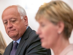 David Marit, (left) Minister of Agriculture for Saskatchewan, looks down as Marie-Claude Bibeau, federal Minister of Agriculture and Agri-Food, speaks during a media conference of provincial and federal agricultural ministers at Delta Hotels in Saskatoon, Sask. on Friday, July 22, 2022.