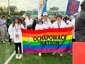 Jaylie Yuzicapi, Beau Bear, Trey Bear and Crystal Bear carry the Ochapowace First Nation Pride Flag at the 2022 Tony Cote Summer Games. As part of an ongoing commitment to LGBTQ2S+ inclusion, the First Nation is encouraging children to join the sports teams that best align with their gender identity.