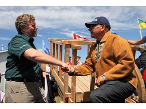 Metis-Nation Saskatchewan President Glen McCallum shakes hands with a Parks Canada representative during a land transfer ceremony in Batoche on Friday, July 22.