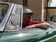 Saskatchewan British Car Club vice president Terry Yuzik sits in his 1964 MGB for a photograph in front of Delta Bessborough Hotel in Saskatoon, on Friday, July 15, 2022.
