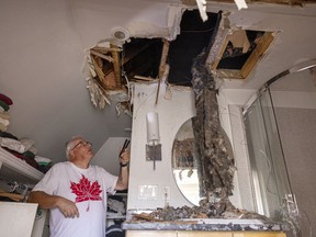 Homeowner Aydon Charlton stands in the top floor bathroom where it is believed lighting struck the house and caused a fire in the attic early on Thursday, July 14, 2022 in Regina.