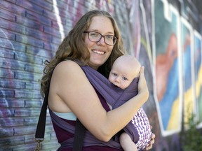 Sydney Brandt, and her two-and-a-half-month-old son Harris, finishing up at their parent and baby group at the Cathedral Community Centre on Thursday, July 14, 2022 in Regina. TROY FLEECE / Regina Leader-Post