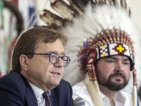 Jonathan Wilkinson, left, minister of Natural Resources, and Chief Richard Ben, Meadow Lake Tribal Council, speak during a clean energy and smart renewable announcement at First Nations University on Monday, July 11, 2022 in Regina.