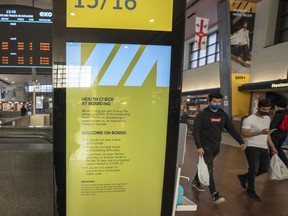 Passengers arrive at a Via Rail kiosk at Central Station in Montreal, Wednesday, Oct. 6, 2021.