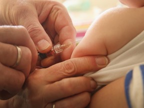 A children's doctor injects a vaccine to an infant on Feb. 26, 2015 in Berlin.