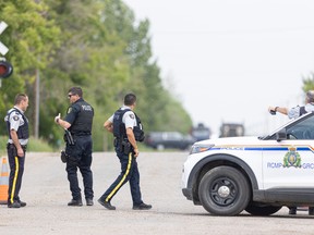 RCMP and other police vehicles are gathered on Park Avenue, north of the railway crossing, in Langham Sask., where one person has been reported dead.