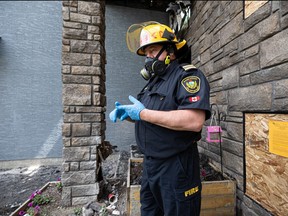 Fire Marshal Brian Conway shows how an improperly disposed cigarette caused a house fire. Photo taken in Saskatoon, Sask. on Wednesday, July 13, 2022.