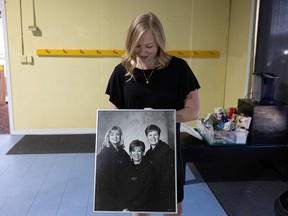 Longtime La Danse studio student Shannon Menon looks at a photo of the three women who founded the studio in 1984. Photo taken in Saskatoon, Sask. Thursday, July 14, 2022.