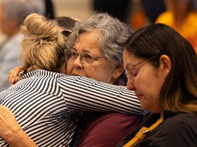 Larissa Burnouf hugs Theresa Walker, the mother of Dawn Walker who went missing Friday evening, along with her 7-year-old son Vincent Jansen, during an FSIN press conference. Photo taken in Saskatoon, Sask. on Monday, July 25, 2022.