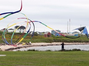 A woman flies her kite Monday, August 6, 2012, in Laverniere on the Magdalen Islands. Prime Minister Justin Trudeau will travel to the beautiful Magdalen Islands in Quebec today.