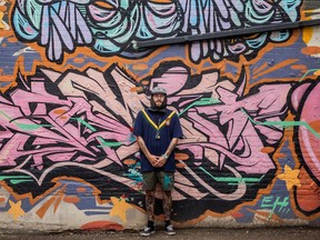 SASKATOON, SK–AUGUST 2/2022 – 0803 news drinkle art q&a – Sleazy stands in front of his artwork on the Drinkle building, which has several of his pieces on display. Photo taken in Saskatoon, SK on Tuesday, August 2, 2022.