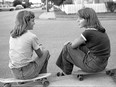 A photo of Leslie Wenzel and Barbara Wolfe taking a break from skateboarding, from Aug. 25, 1978.